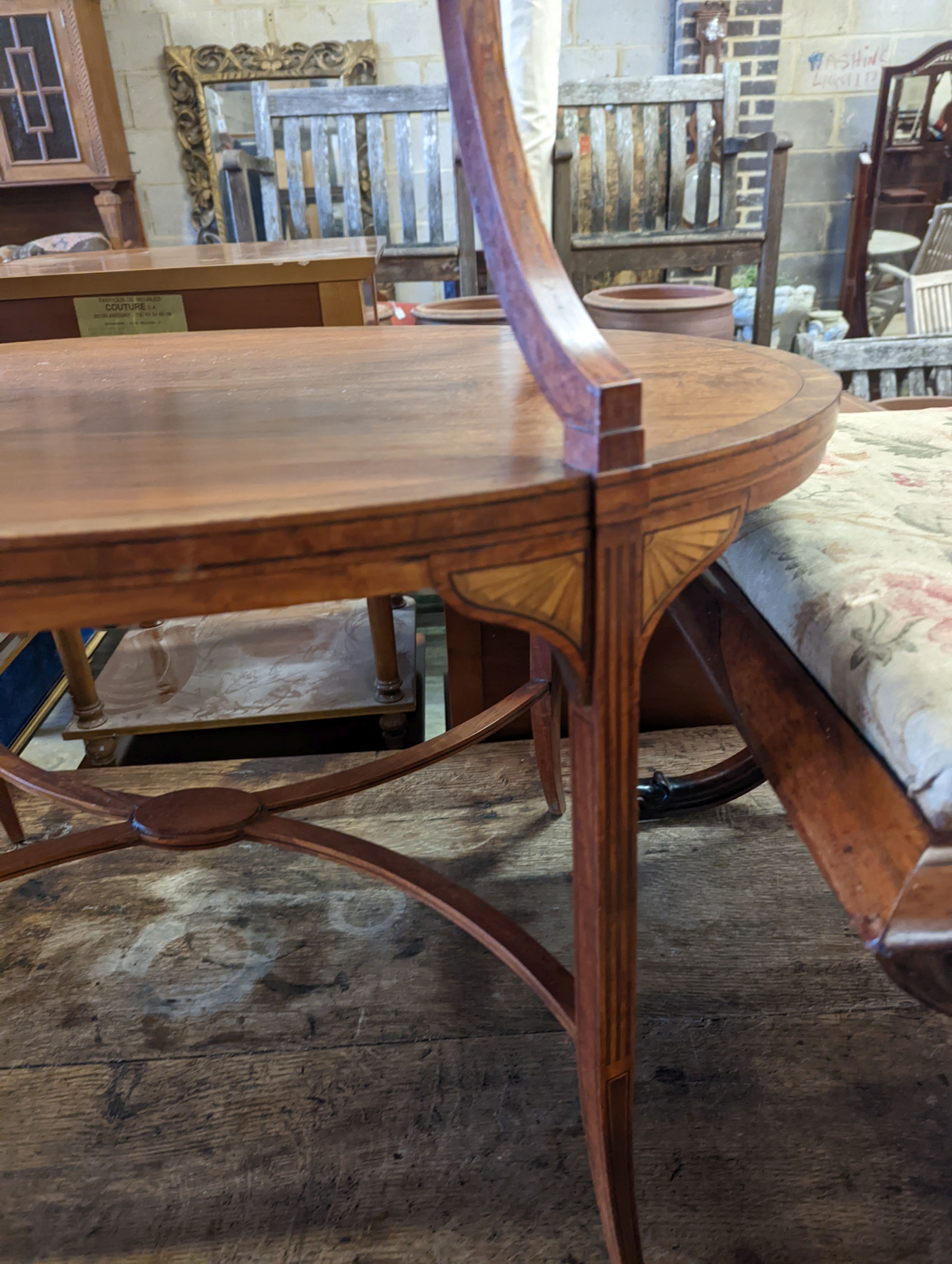An Edwardian Sheraton revival oval inlaid satinwood two tier etagere, width 89cm, depth 55cm, height 77cm